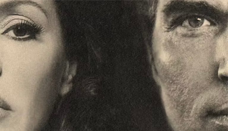 Two faces in close-up profile against a dark background, rendered in stark black and white.